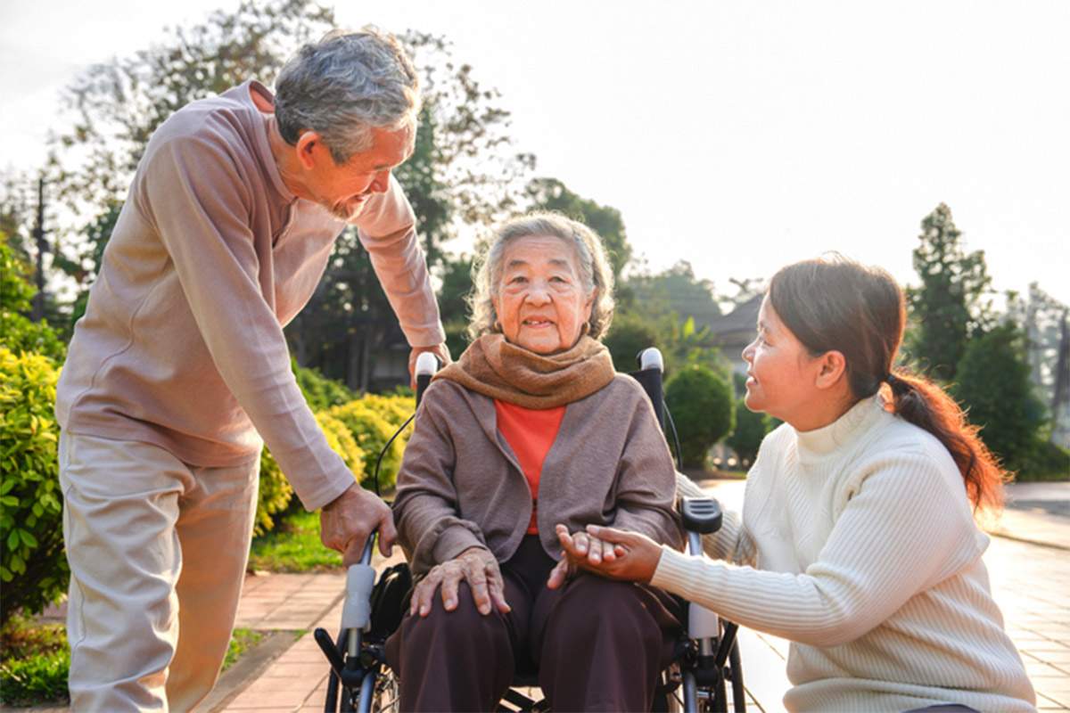 Elderly Person With Family Support Outdoors in NSW
